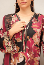 Woman wearing a floral and patterned top with a neutral background