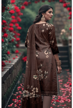 Woman in a brown floral dress standing among red flowers