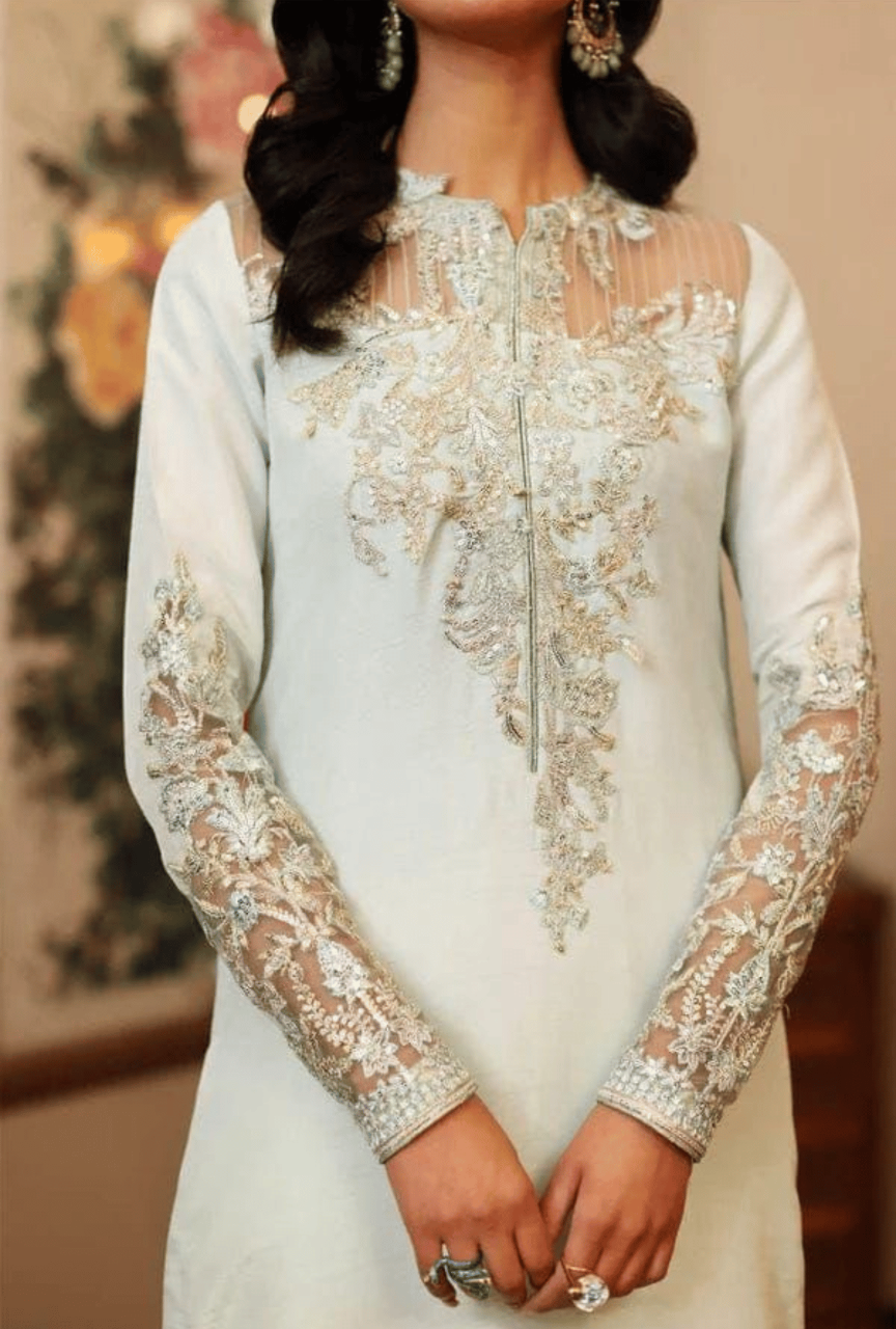 White lace dress with long sleeves on a blurred background