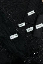 Black textured fabric with labeled parts on a black background