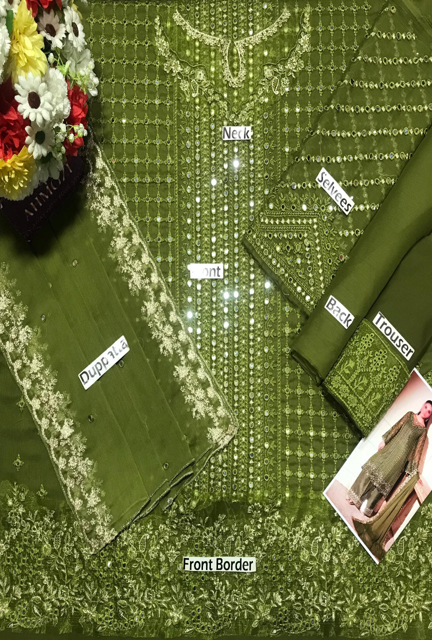 Green fabric with floral embroidery and labels on a green background