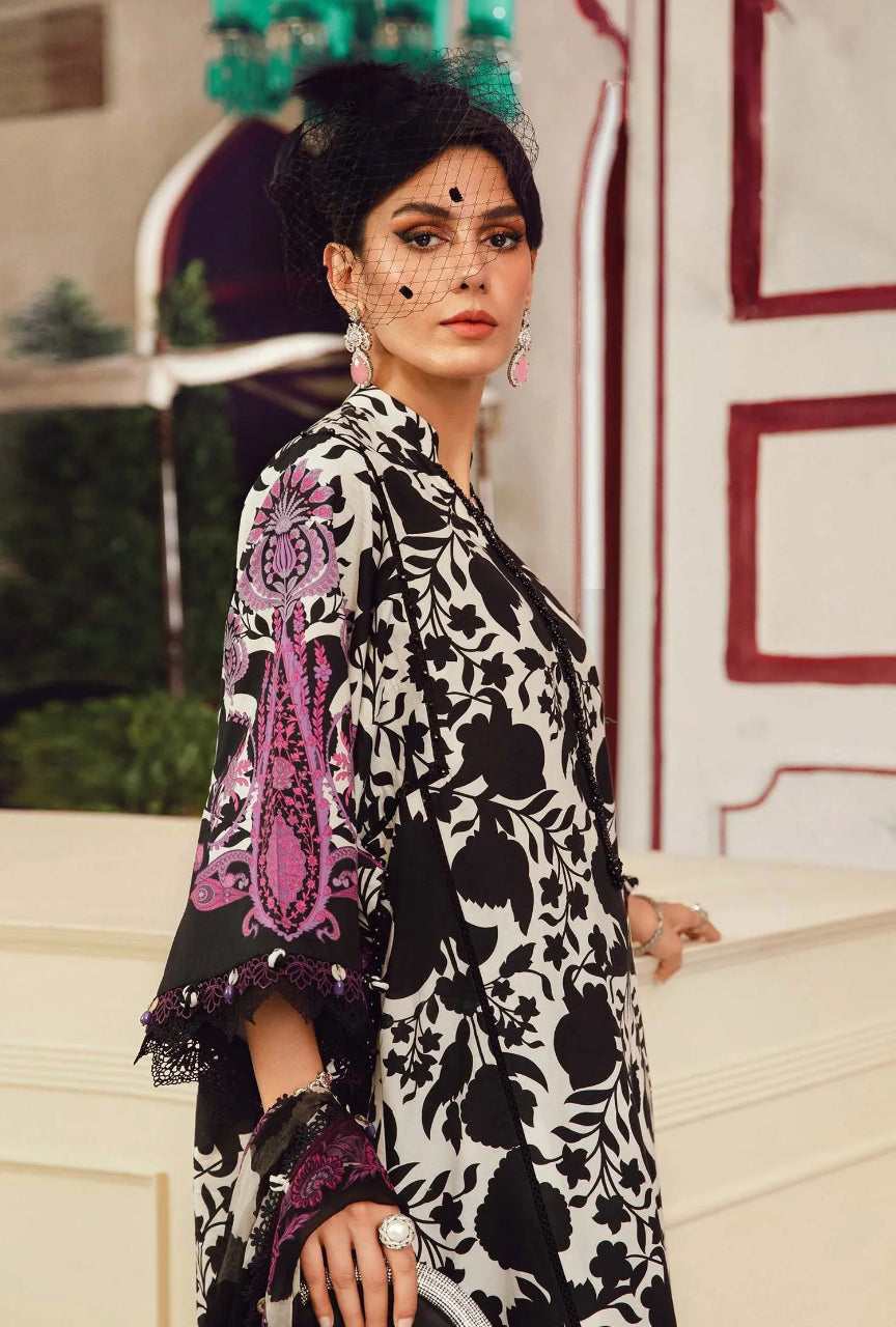 Woman wearing a black and white patterned outfit with purple accents outdoors.