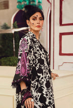 Woman wearing a black and white patterned outfit with purple accents outdoors.