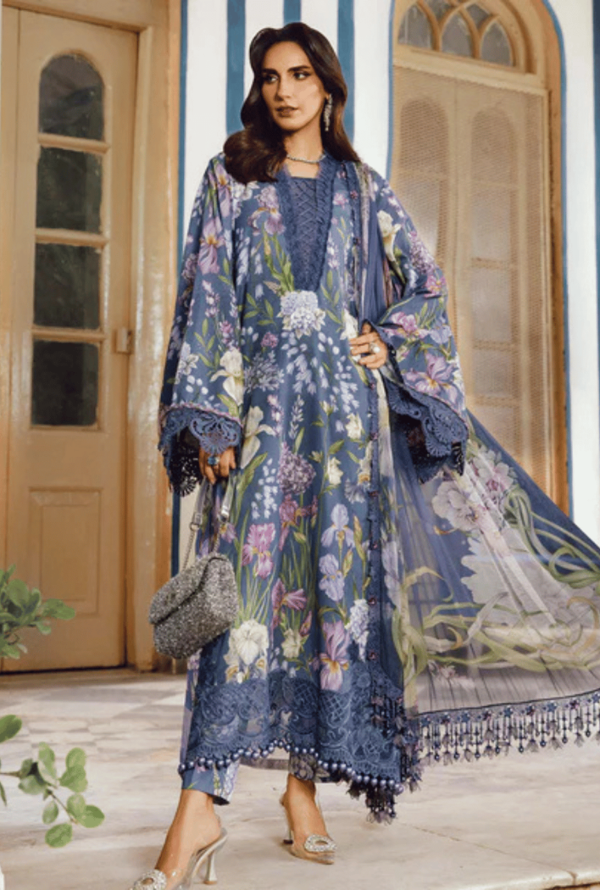 Woman wearing a floral dress with a matching shawl in an outdoor setting.