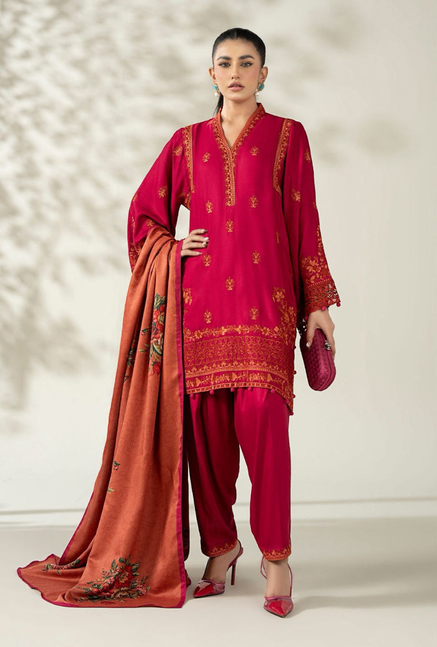 Woman wearing a red embroidered outfit with a matching dupatta on a neutral background