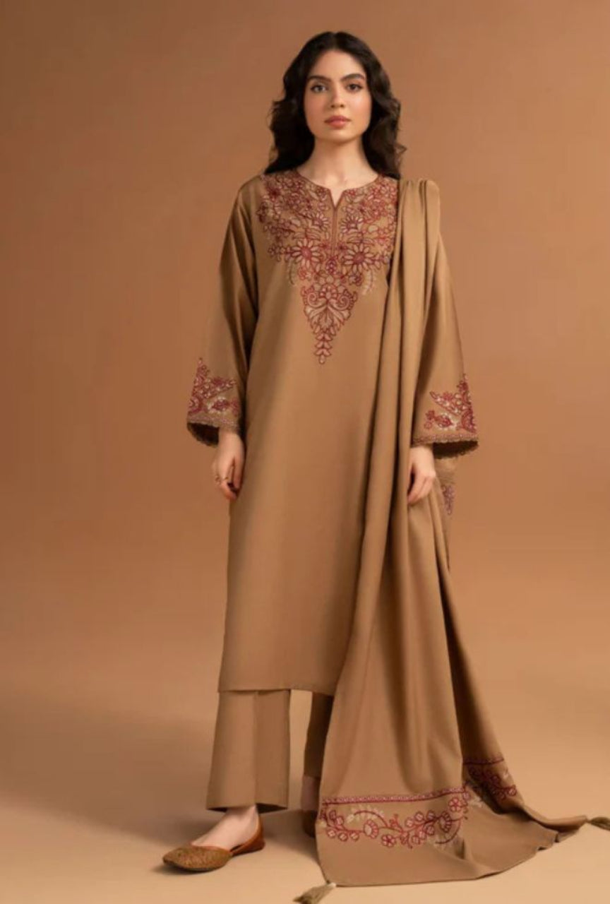 Woman wearing a beige embroidered traditional outfit on a brown background