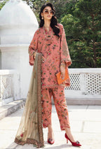 Woman in a pink floral outfit with a beige dupatta standing outdoors.