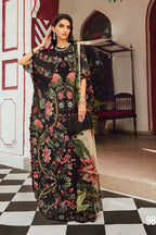 Woman wearing a floral dress in an indoor setting with checkered floor and decorative wall.