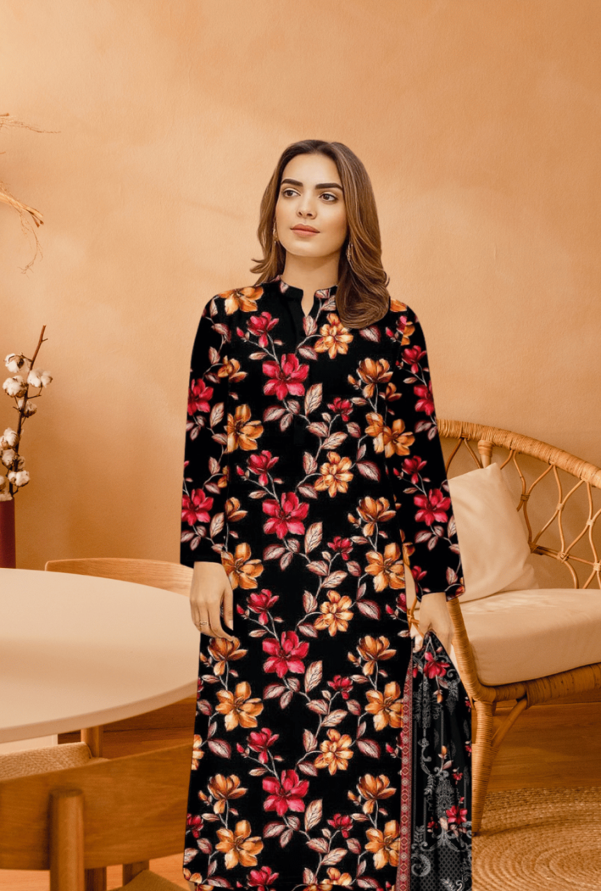 Woman wearing a floral dress in an indoor setting with a beige wall and wooden furniture.