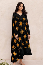 Woman wearing a black floral dress against a beige wall