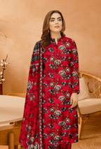 Woman wearing a red floral dress with a matching dupatta in an indoor setting.