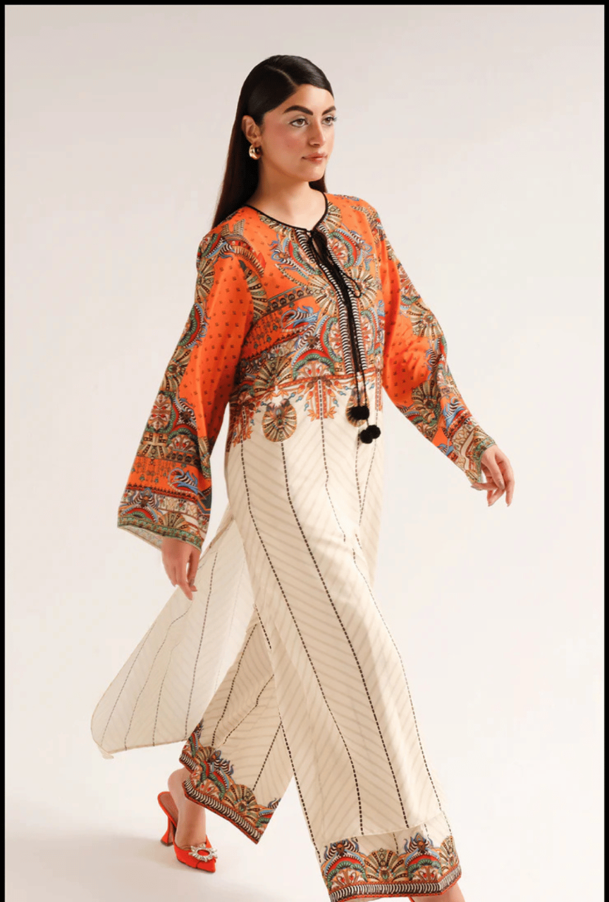 Woman wearing a traditional outfit with an orange top and white pants on a plain background