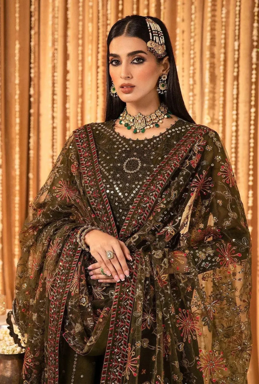 Woman in traditional embroidered outfit with jewelry against a decorative background