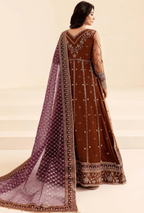 Woman wearing a brown embroidered outfit with a purple dupatta on a beige background