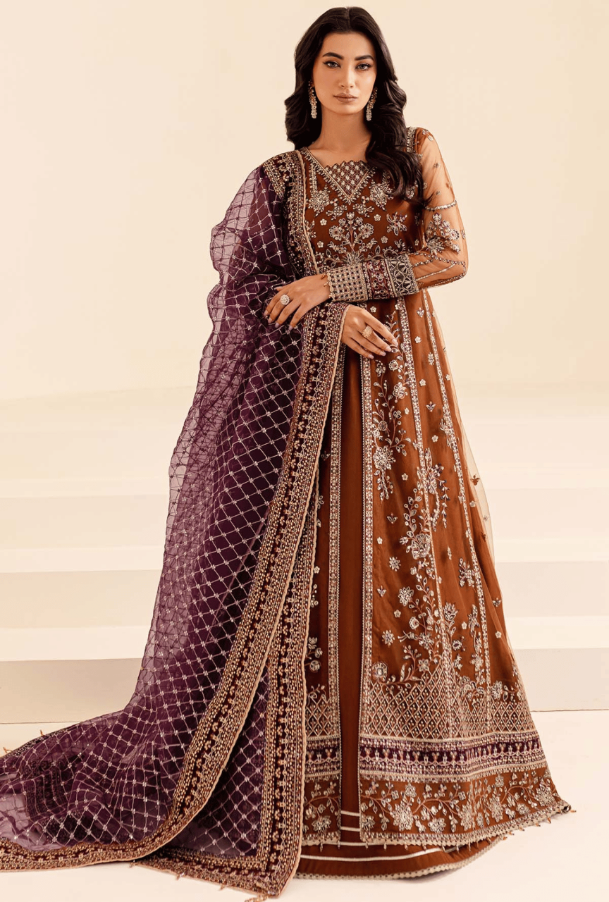 Woman wearing a traditional outfit with a purple and brown color scheme on a plain background