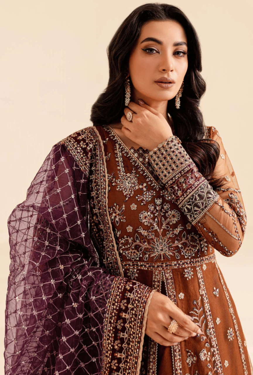 Woman wearing a traditional outfit with intricate patterns on a beige background