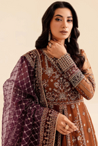 Woman wearing a traditional outfit with intricate patterns on a beige background