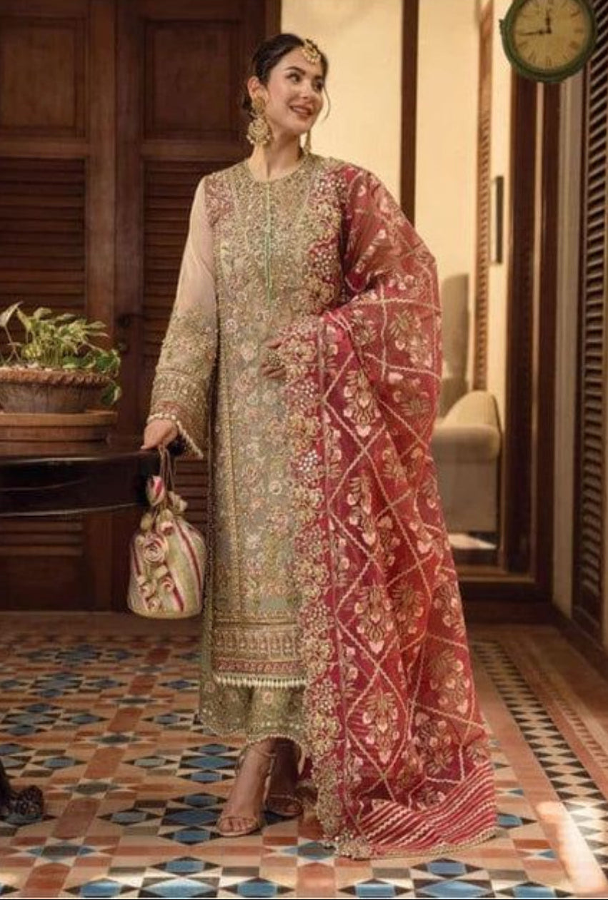 Woman in traditional embroidered outfit standing in a decorated room with patterned floor.