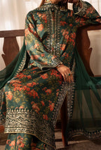 Traditional embroidered outfit with floral patterns on a wooden chair.