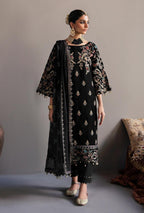 Woman wearing a black embroidered outfit with a matching dupatta against a neutral background