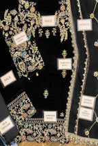 Embroidered fabric with jewelry labels on a black background