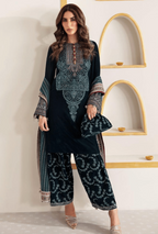 Woman wearing a black and blue embroidered outfit with a white wall background