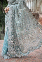 Decorative saree with intricate patterns on a textured surface