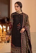 Woman wearing a black embroidered traditional outfit with a chandelier in the background