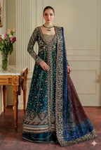 Woman in a traditional embroidered outfit with a blue dupatta in an elegant room.