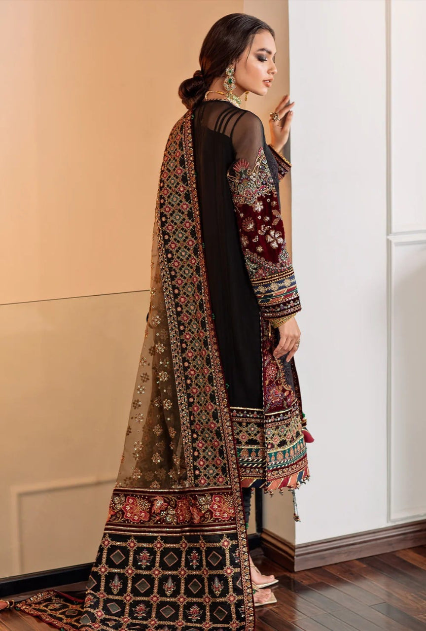 Woman wearing a traditional embroidered outfit in a room with a neutral color scheme.