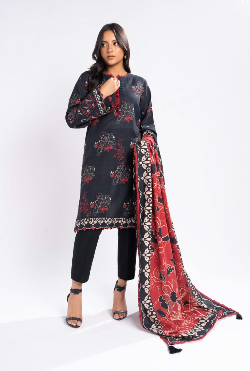 Woman wearing a black and red patterned outfit with a matching dupatta on a white background
