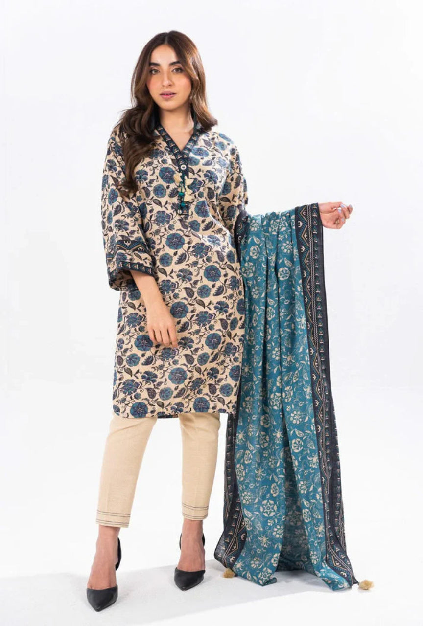 Woman wearing a floral kurta with beige pants and holding a matching dupatta on a white background