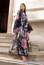 Woman in a floral dress and scarf standing on stone steps.
