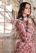 Woman in a floral dress standing in front of white flowers
