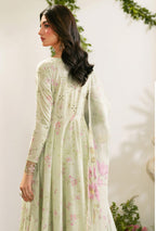 Woman wearing a light green floral dress with a white dupatta against a white background