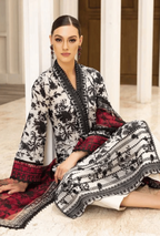 Woman wearing a black and white patterned outfit with red accents indoors.