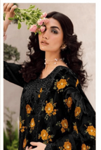 Woman wearing a black floral dress with a blurred background