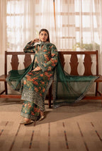 Woman in a floral traditional outfit sitting on a wooden bench with curtains in the background