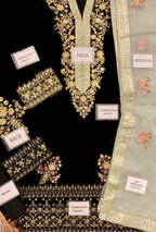Embroidered fabric pieces with labels indicating parts of a traditional outfit on a black background.